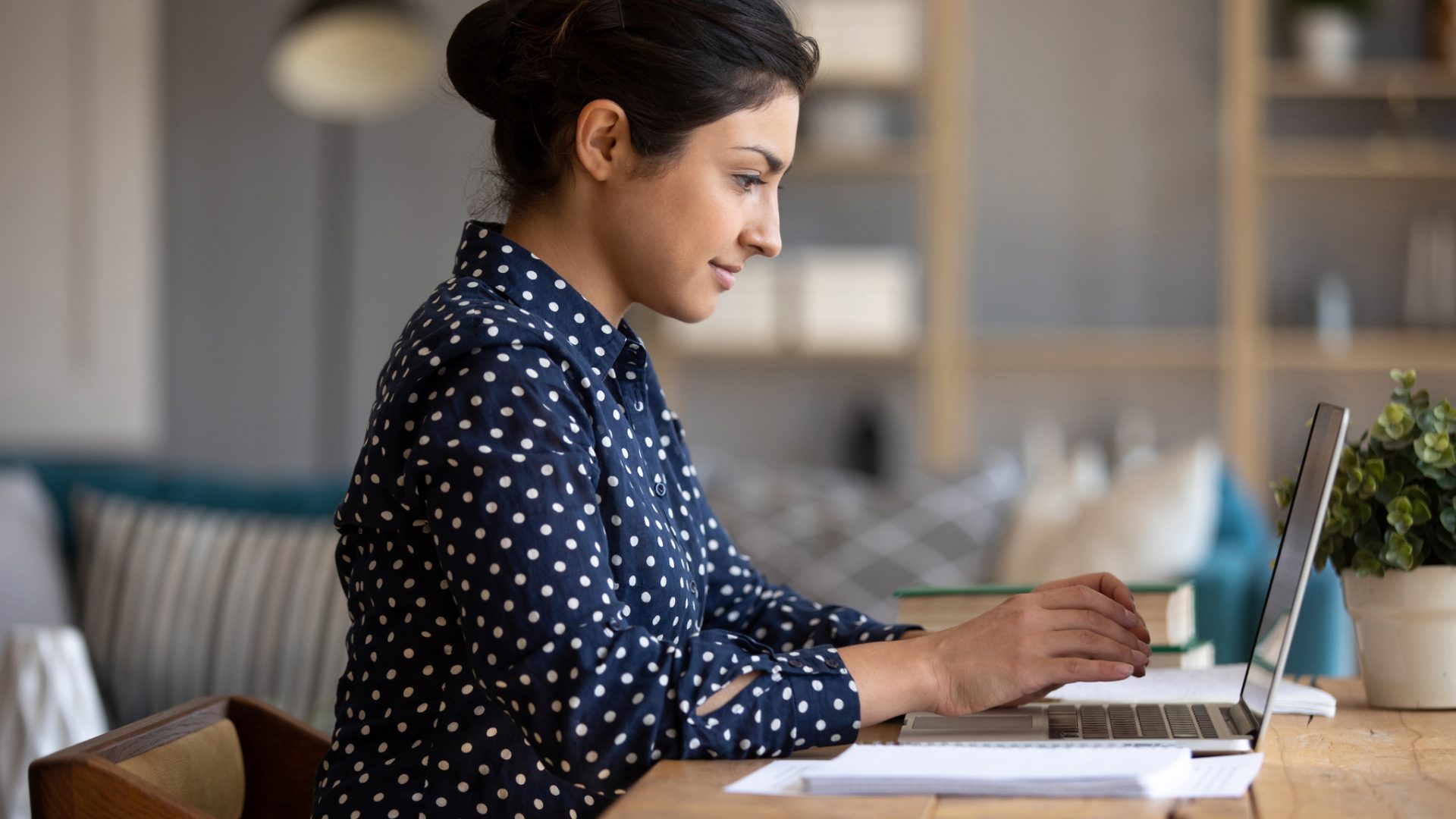 Indian girl using laptop studying