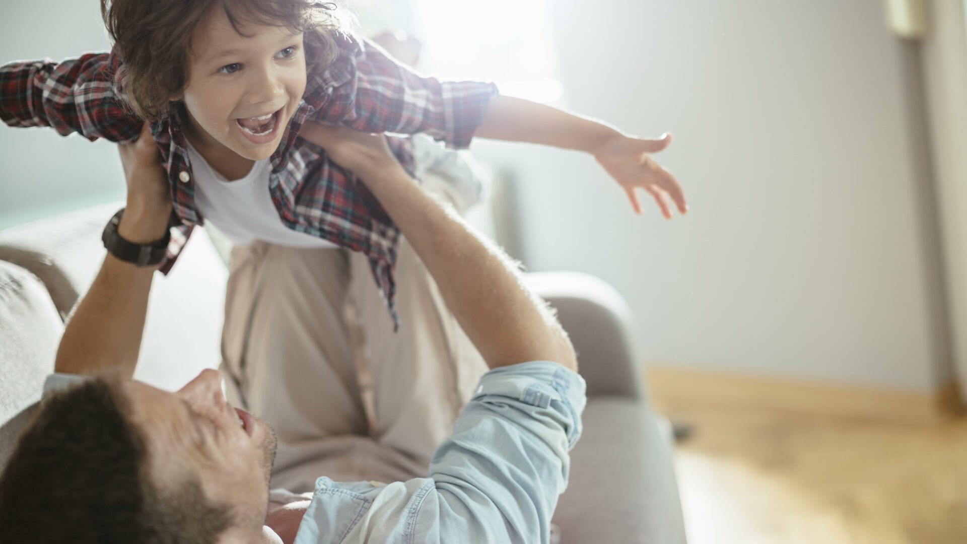 father and child playing in the living room