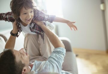 father and child playing in the living room