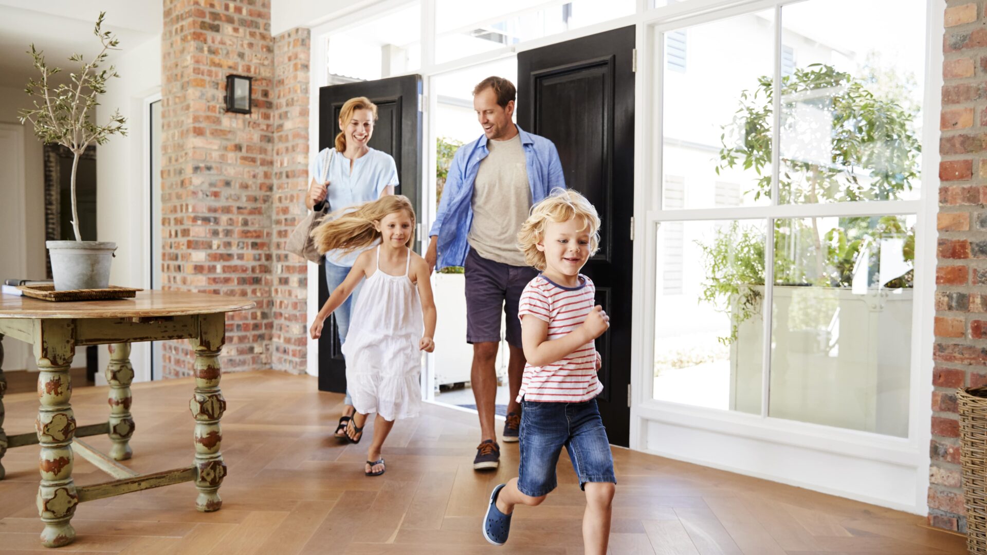 family running into their new house
